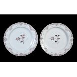 A pair of Dutch Delft chargers , mid 18th century, with shaped rims and painted in manganese with