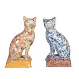 Two similar Staffordshire models of seated cats , late 19th century, one mottled blue the other
