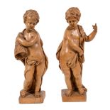 A pair of Flemish sculpted limewood models of putti, early 18th century, portrayed standing and