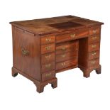 A George III mahogany kneehole desk , circa 1760, the cleated rectangular top hinged to be raised