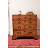 A George II walnut and featherbanded chest of drawers, circa 1740, attributed to Giles Grendey, the