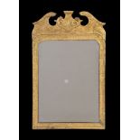 A George I giltwood and gesso mirror , circa 1720, the rectangular plate within a foliate incised