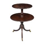 A George III mahogany dumb waiter , circa 1800, the two circular graduated drop leaves with