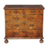 A Queen Anne walnut chest of drawers, circa 1710, inlaid with stringing throughout, the quarter