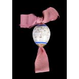 A Russian porcelain Easter egg and pink ribbon , late 19th c entury, gilt with a stylized foliate