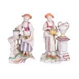 A pair of German faience figures of maidens of Damm type , circa 1800, one holding a hurdy gurdy,