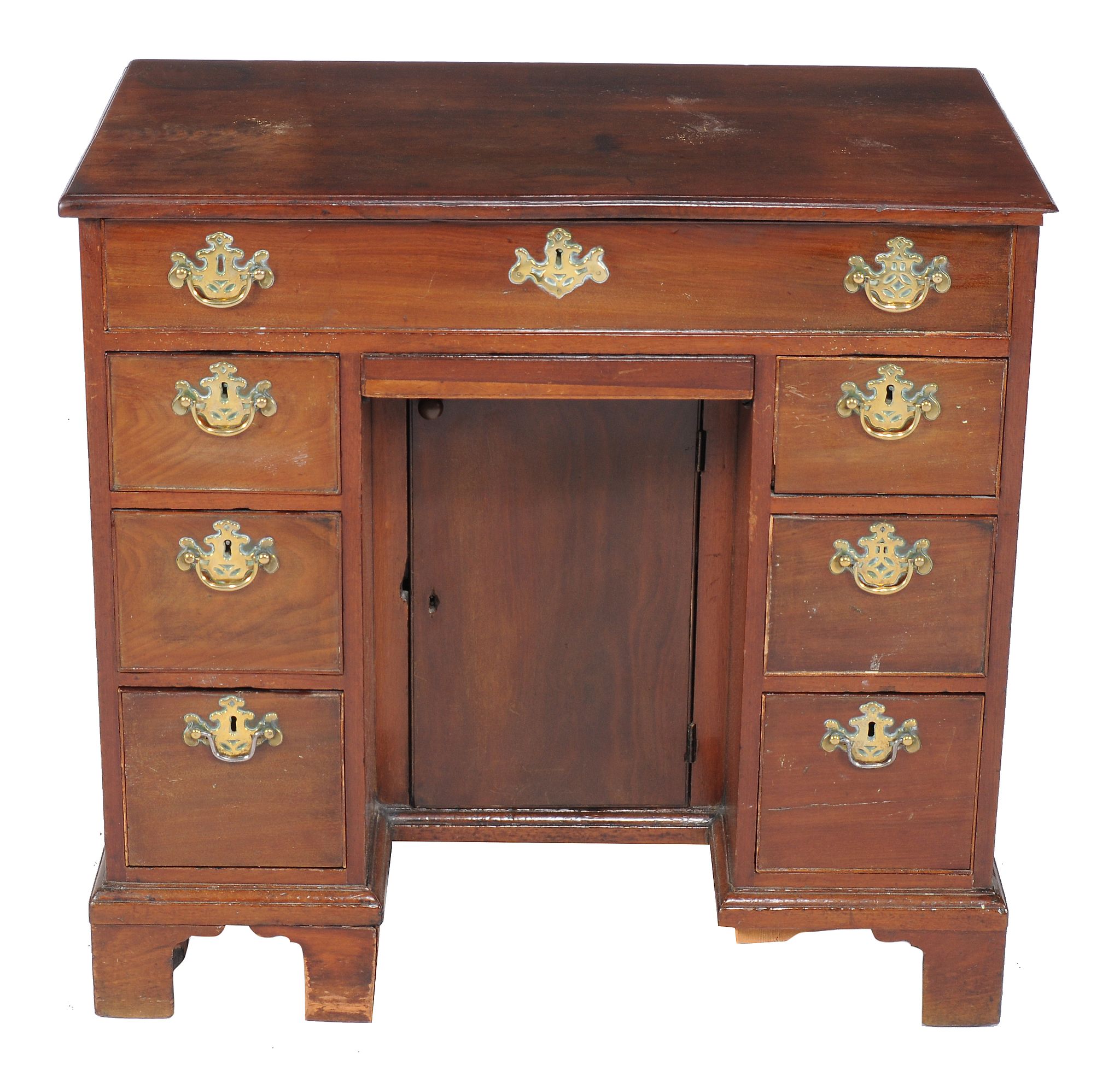 A George III mahogany kneehole desk, circa 1800, with an arrangement of seven drawers and a shallow