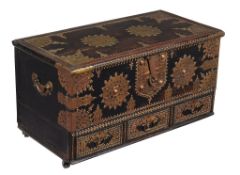 A Zanzibar metal mounted and studded hardwood coffer, of small proportion, on later castors, 60cm