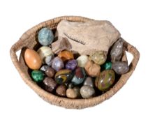 A collection of twenty-four polished hardstone and mineral specimen eggs, including two malachite