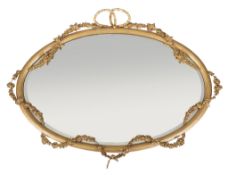A Victorian giltwood and composition wall mirror, circa 1870, the oval plate surrounded by applied