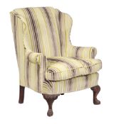 A mahogany and upholstered wing armchair, in George III style, late 19th/ early 20th century, the