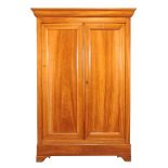 A Continental hardwood armoire , 19th century, the panel doors enclosing three shelves, and a blind