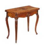 A Victorian walnut card table in French taste , circa 1860, the bookmatched veneered top with