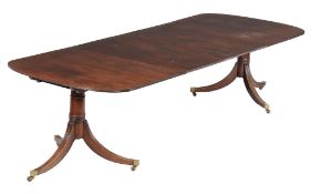 A mahogany twin pedestal dining table , early 19th century and later, with two additional leaf