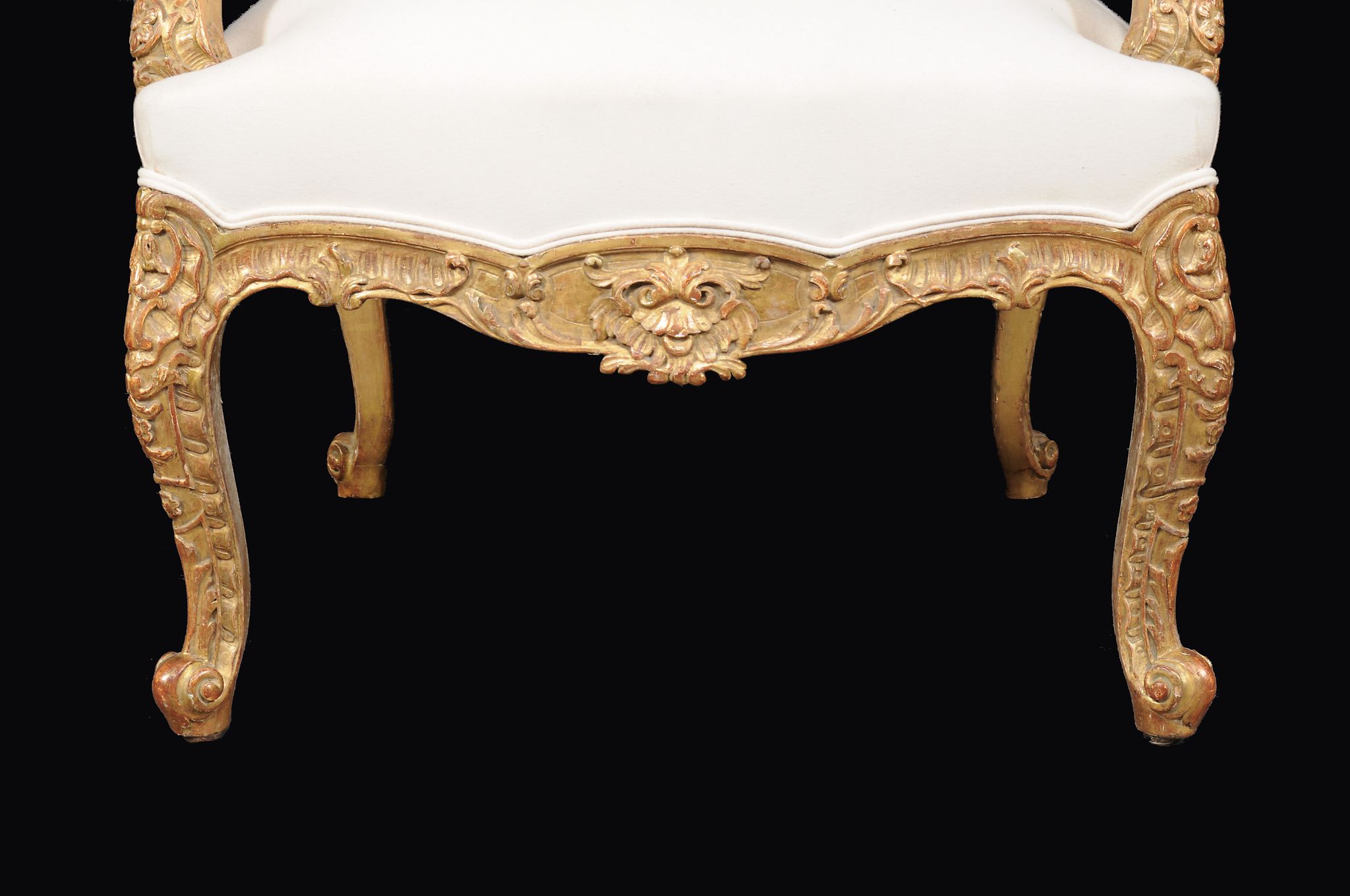 A carved giltwood wing armchair in Louis XV style , 20th century, upholstered in plain calico, - Image 2 of 2