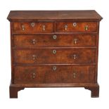 A George I walnut chest of drawers , circa 1720, with two drawers above three further long drawers,