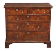 A George I walnut chest of drawers , circa 1720, with two drawers above three further long drawers,