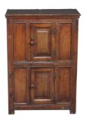 An oak mural type cupboard , late 17th century/ early 18th century and later, with double panelled