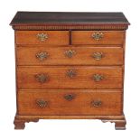 A George III oak chest of drawers , circa 1770, with dentil cornice above two short and three long