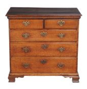 A George III oak chest of drawers , circa 1770, with dentil cornice above two short and three long