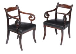 A pair of Regency mahogany and leather upholstered armchairs , circa 1820, each with black leather