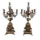 A pair of French gilt metal six light candelabra, circa 1900, the sockets and drip pans on foliate