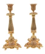 A pair of Louis Philippe gilt bronze candlesticks, mid 19th century, the foliate cast sockets on