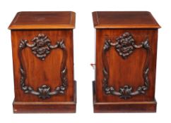 A pair of Victorian mahogany pedestal cabinets , circa 1870, each with applied mouldings to the