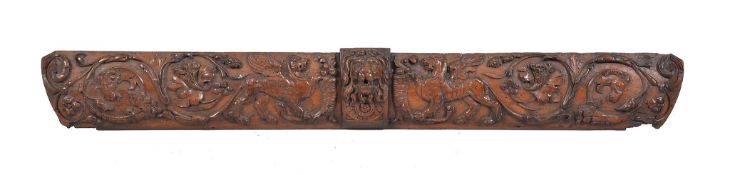 An Italian carved walnut panel, probably originally a drawer front, 17th century, the central