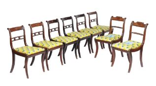 A harlequin set of six Regency mahogany dining chairs , circa 1815, each with carved paterae to the