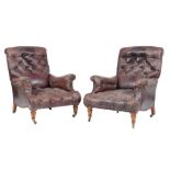 A pair of Victorian oak and leather upholstered armchairs , late 19th century, in the manner of