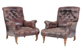 A pair of Victorian oak and leather upholstered armchairs , late 19th century, in the manner of