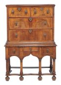A walnut chest on stand , early 18th century and later, the chest top and drawer base associated,