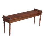 A mahogany hall seat in George IV style , late 19th century, with scrolled ends above the seat and