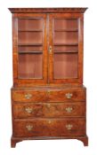 A walnut feather banded bookcase cabinet , circa 1740 and later, the associated cabinet top with