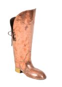 A Victorian planished copper stick stand modeled as a boot , late 19th century, with later leather