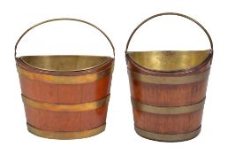 Two similar mahogany and brass banded buckets or 'kettle stands', early 19th century, each of