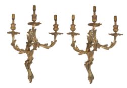 A pair of gilt metal three light wall appliques in Louis XV style, 20th century, the electrical