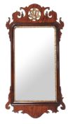 A George III mahogany and parcel gilt wall mirror , circa 1760, the fretwork frame with gilt