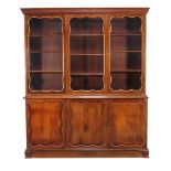 A French mahogany and parcel gilt cabinet bookcase , 20th century, the glazed doors enclosing