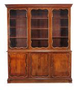 A French mahogany and parcel gilt cabinet bookcase , 20th century, the glazed doors enclosing