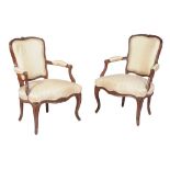 A pair of Louis XV carved beech and upholstered armchairs , mid 18th century, each stamped A.C. to