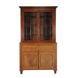 Ω A Regency mahogany secretaire bookcase , circa 1820, in the manner of George Bullock, with
