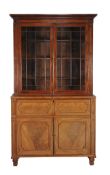 Ω A Regency mahogany secretaire bookcase , circa 1820, in the manner of George Bullock, with