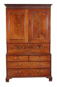 A George III mahogany secretaire clothes press, circa 1770, the dentil, arcaded and blind fret