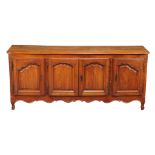 A Louis XV cherry dresser base , mid 18th century, with a central pair of shaped panel doors and