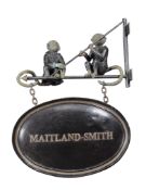 A shop sign in late Victorian style, 20th century, the oval sign for MAITLAND-SMITH suspended by