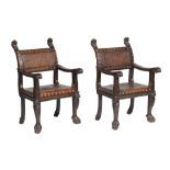 A pair of Italian carved oak and embossed leather upholstered chairs , early 20th century, the