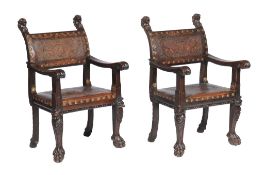 A pair of Italian carved oak and embossed leather upholstered chairs , early 20th century, the