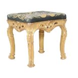 A George III carved giltwod stool, circa 1770, the needlework seat above a pierced acanthus and c-